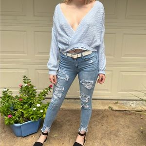 light blue medium sized deep v neck sweater